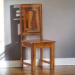 Solid wood dining chair with slatted back for restaurants and homes.