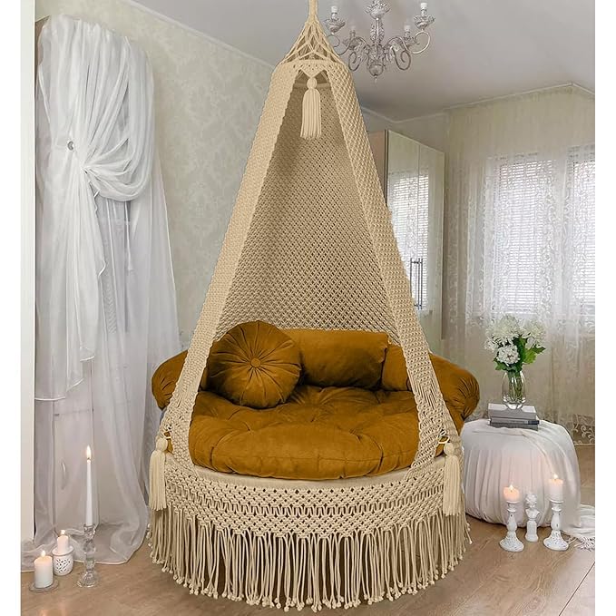 Premium Indoor Loungers and Hanging Swings Chennai. Hand-woven macramé indoor hanging swing chair with a comfortable brown cushion in a balcony setting.